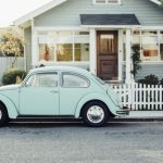 A beetle classic car outside a home
