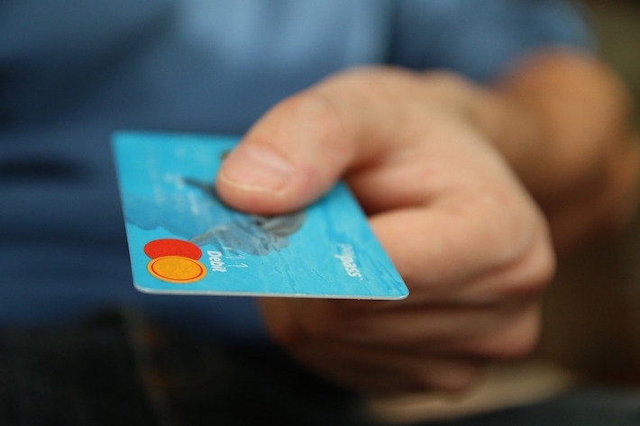 a man handling out a credit card