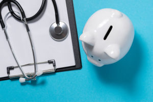 stethoscope and piggy bank