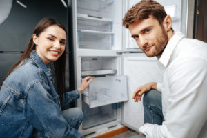 Couple looking at refrigerator