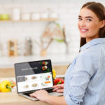 Woman shopping online at Coles and Woolworths