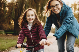 A mother and daugther happily biking