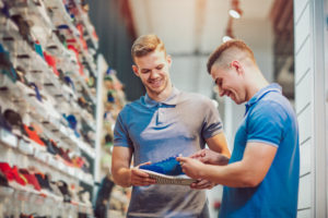 Two man deciding on new running shoes