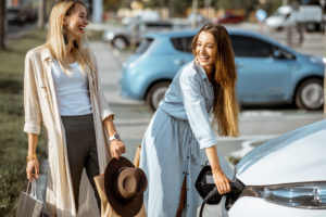 Women charging an electric car