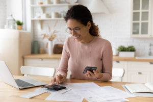 Woman checking savings on her energy bill after switching provider