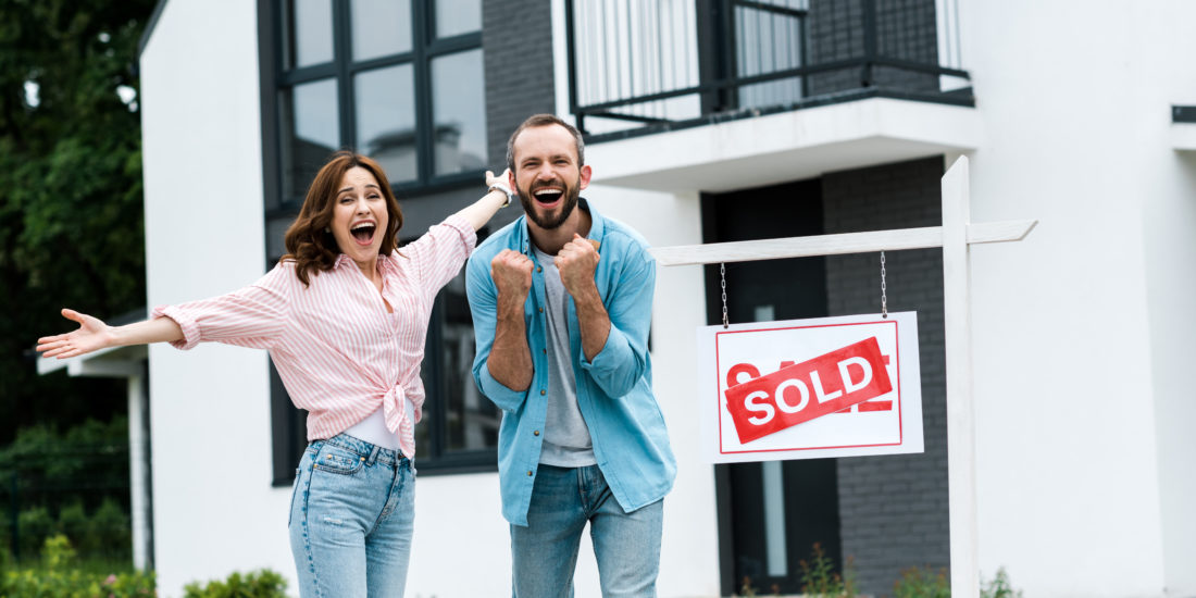 cheerful man and woman buying a home successfully