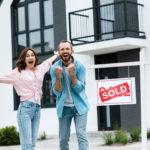 cheerful man and woman buying a home successfully