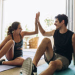 Couple giving each other high five after finding the right gym membership for them