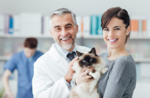 A woman with her cat at the veterinary clinic