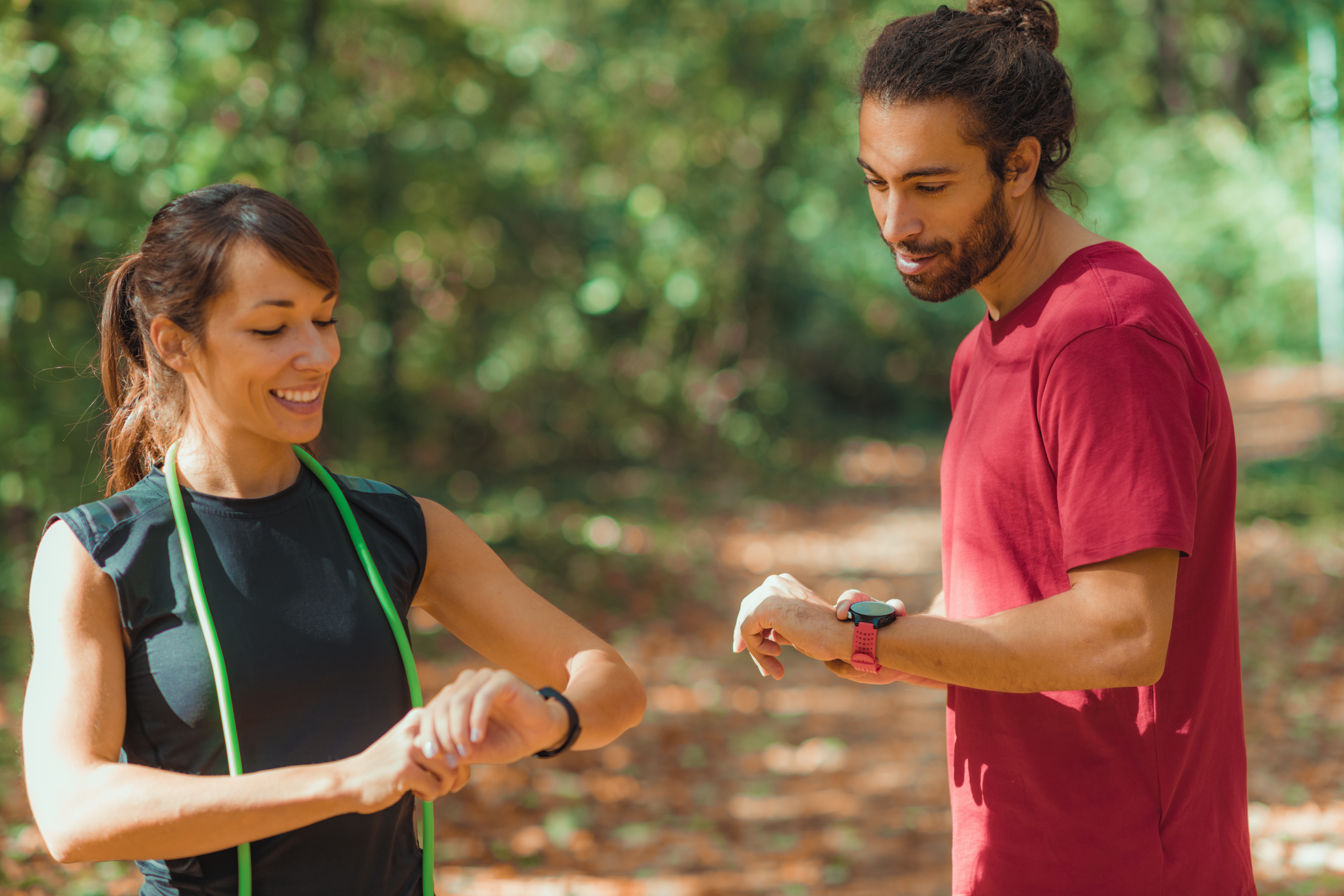 Young couple Looking at Their Fitness Tracker After Outdoor Training