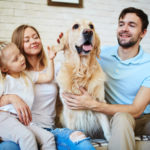 A happy family and their dog with pet insurance