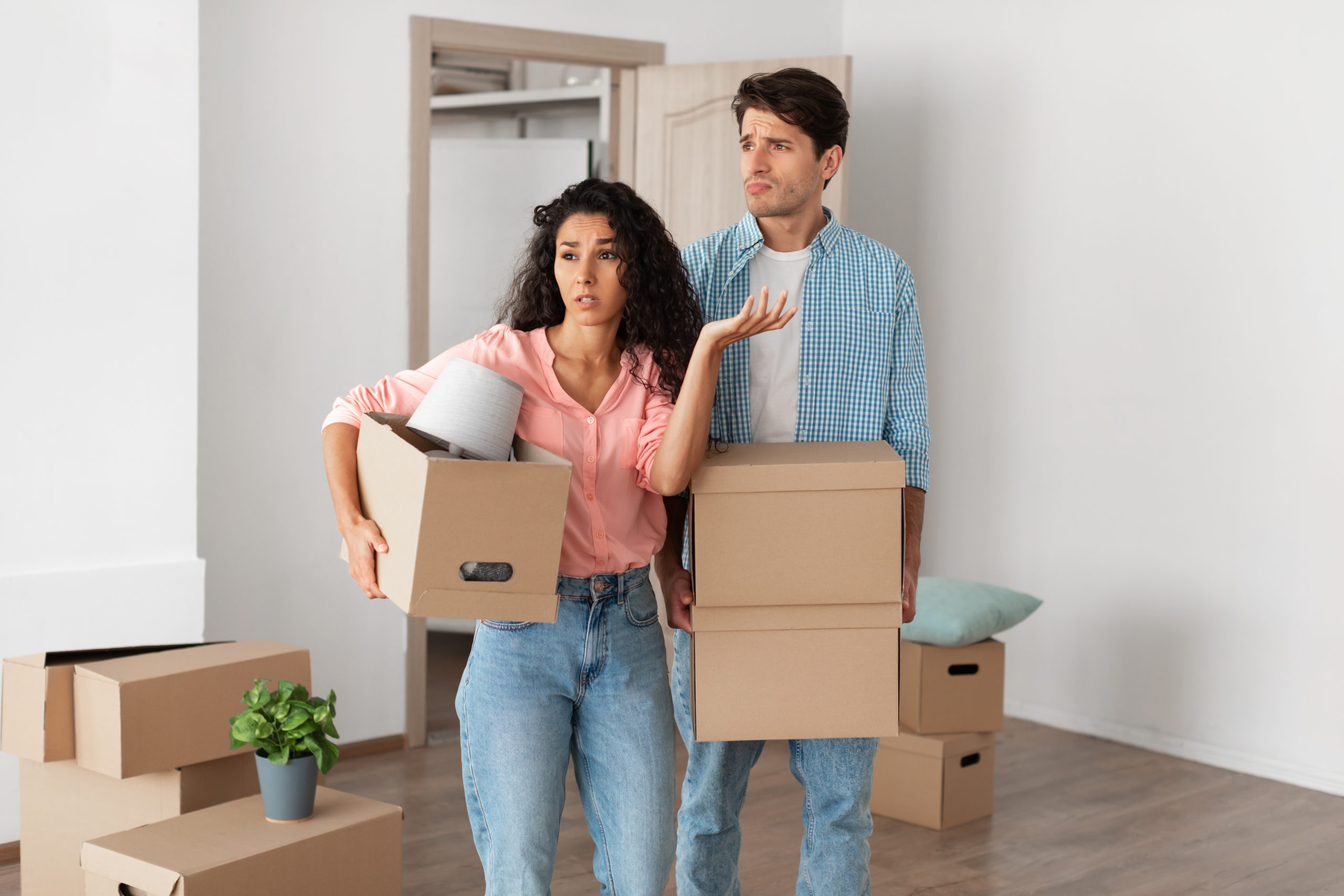 Frustrated or angry couple moving in to their new rental home