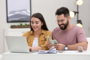 Happy couple checking ASIC's search tool for unclaimed money