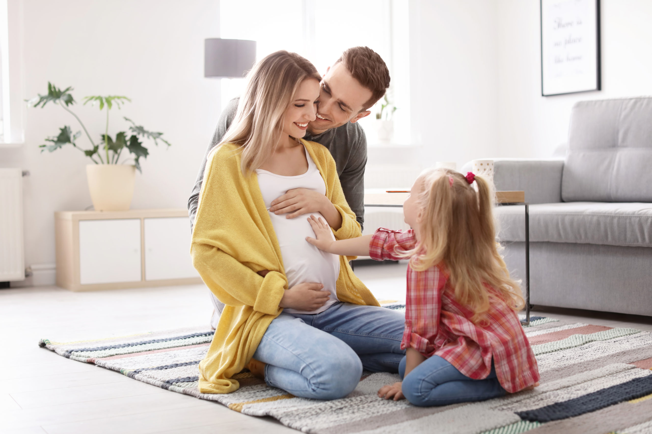 Happy family rejoicing pregnancy at home