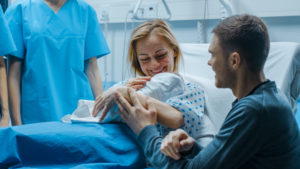 Mother holding a newborn baby in a hospital