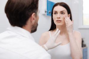 A woman unsure about her cosmetic surgeon