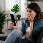 An upset woman that just received a text scam