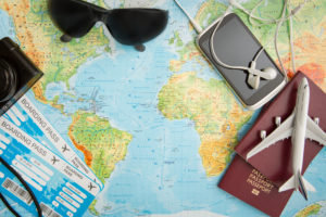 A travel planning map and holiday ticket at a desk