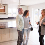 A mortgage broker helping a couple refinance their home loan