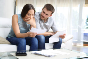 Worried couple checking better home loan rates