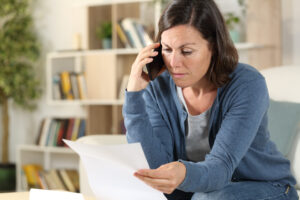 A woman calling to apply for financial hardship assistance