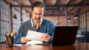 A man checking his financial hardship assistance options