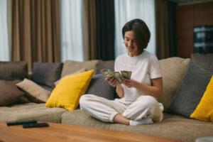 A young woman holding cash from payday loan