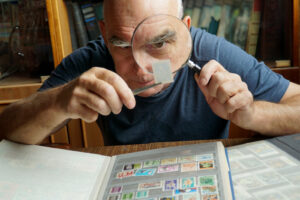 A man examining a stamp collection