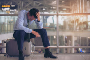 A business man stranded at the airport after flight was cancelled
