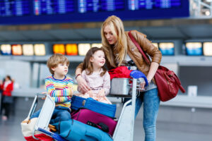 A woman at an airport traveling with her children
