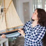A woman showing her boat collectibles