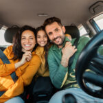 Excited family embracing sitting in their newly leased car
