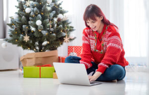A woman online shopping for Christmas presents