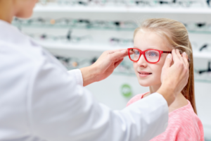 An optometrist helping a customer select eye glasses