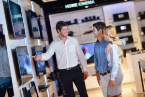 Couple buying extended warranty for TV in an appliance store