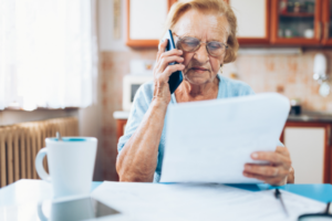 An elderly woman calling her insurance company to complain about a denied claim