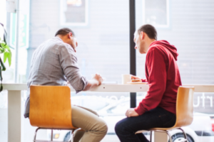 An online seller meeting a buyer at a coffee shop