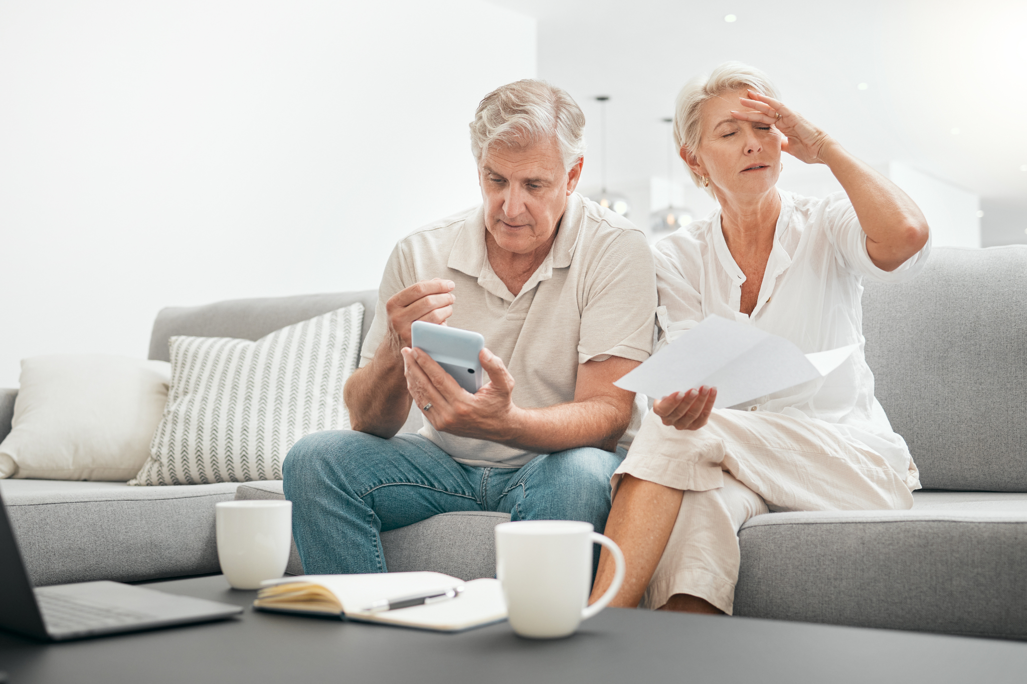 A disappointed couple looking at paperwork after their insurance claim was rejected