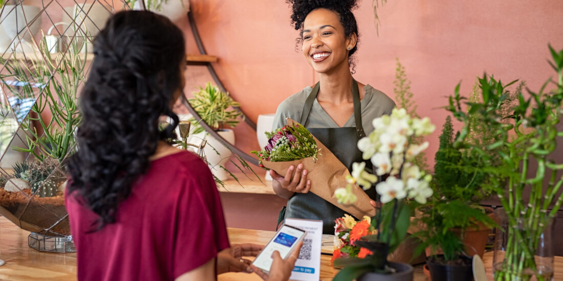 Customer paying with a digital wallet at a flower shop to minimise card surcharges