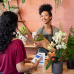 Customer paying with a digital wallet at a flower shop to minimise card surcharges