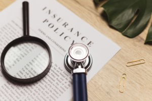 A close up of a pet insurance policy with a magnifying glass, reviewing key details like coverage limits, excess, and exclusions