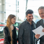 A dealer explaining used car warranties to buyer