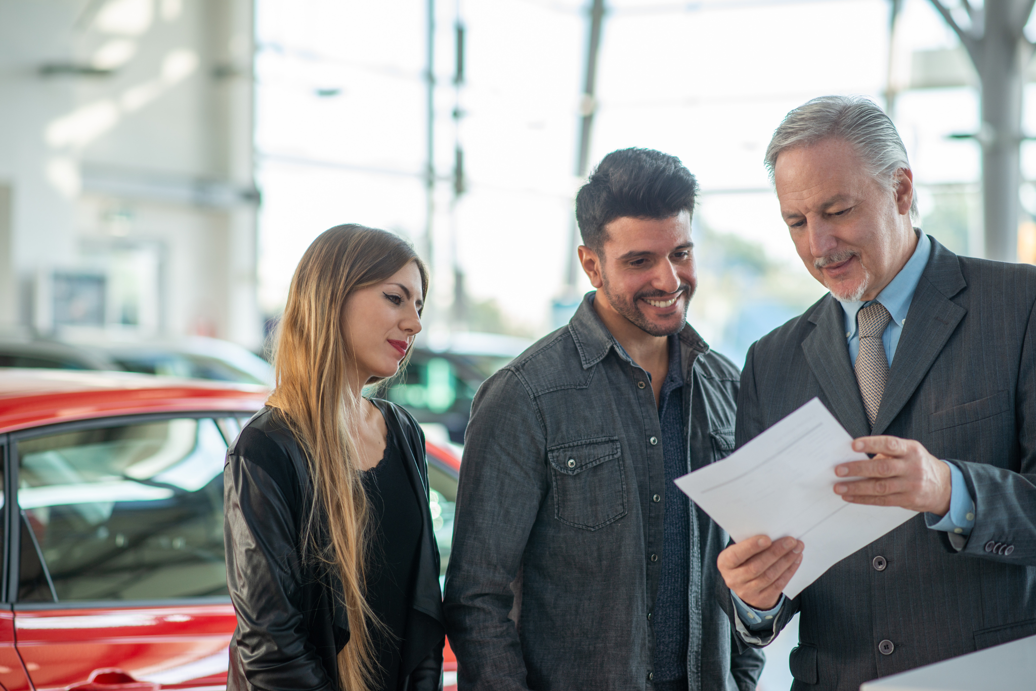 A dealer explaining used car warranties to buyer