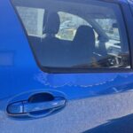 Blue Toyota peeling paint on door