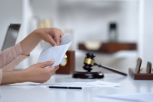Woman holding an envelope with legal documents, deciding to opt out of a class action