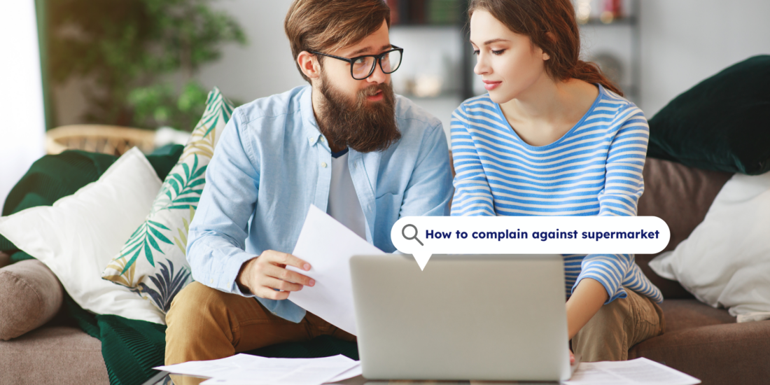 Couple looking at a laptop screen together, researching how to make a complaint against a supermarket