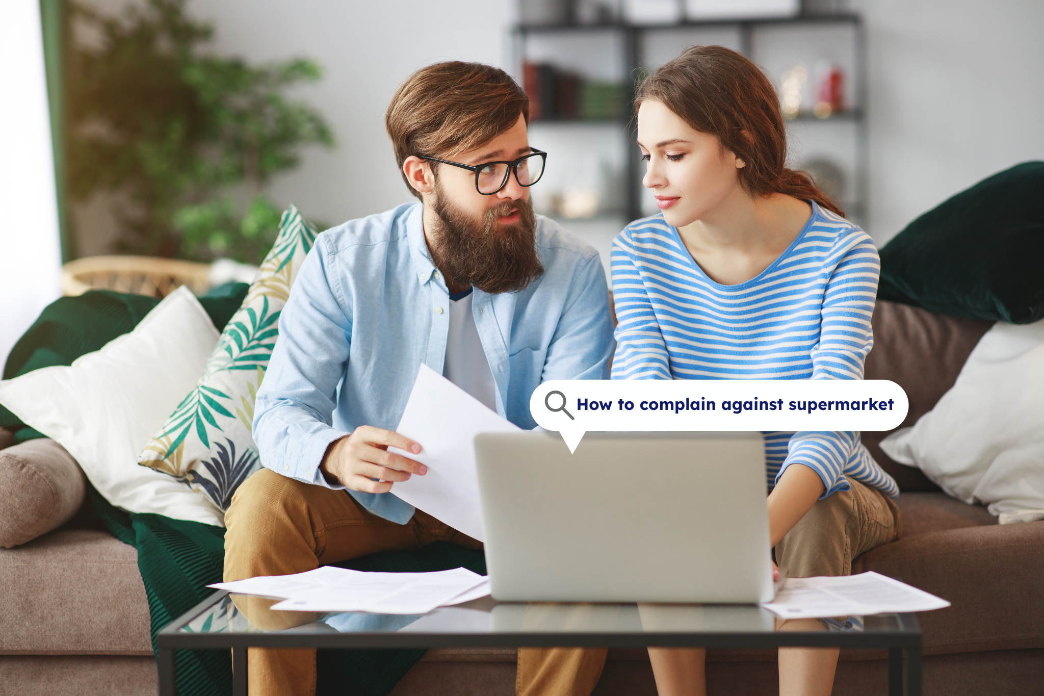 Couple looking at a laptop screen together, researching how to make a complaint against a supermarket