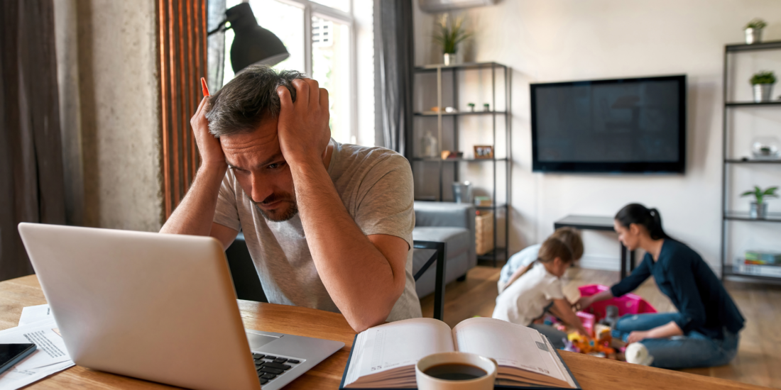 Man working from home on a laptop, preparing to file an income protection complaint