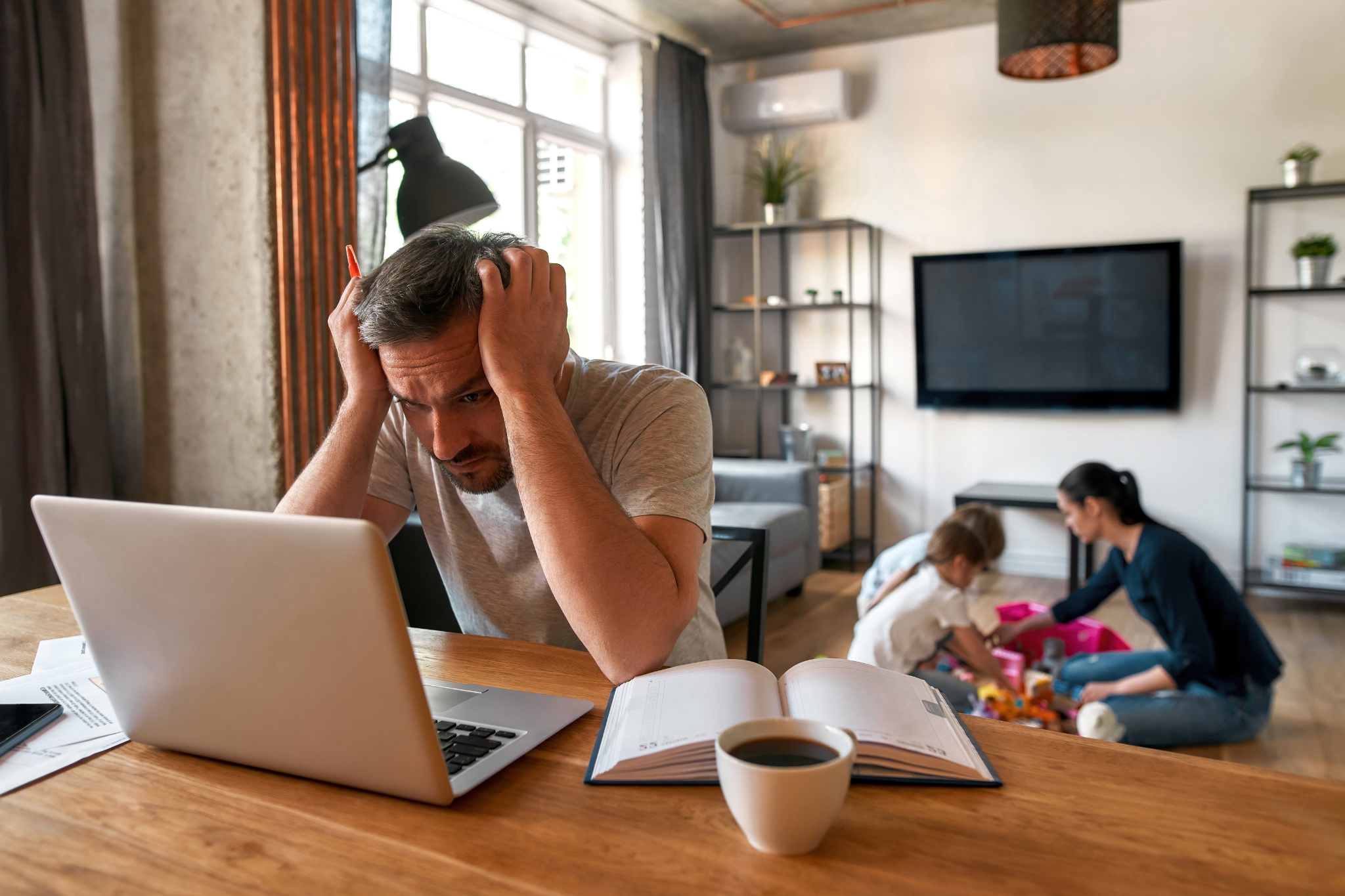 Man working from home on a laptop, preparing to file an income protection complaint