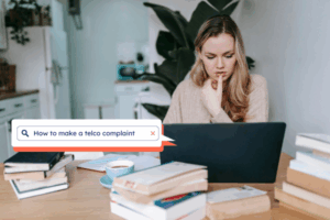 Woman searching online how to make a telco complaint
